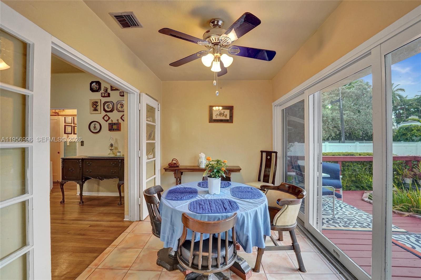 1340 Jackson Street Hollywood, FL 33019 - Photo 19 of 49 a view of a dining room with furniture a chandelier and large windows