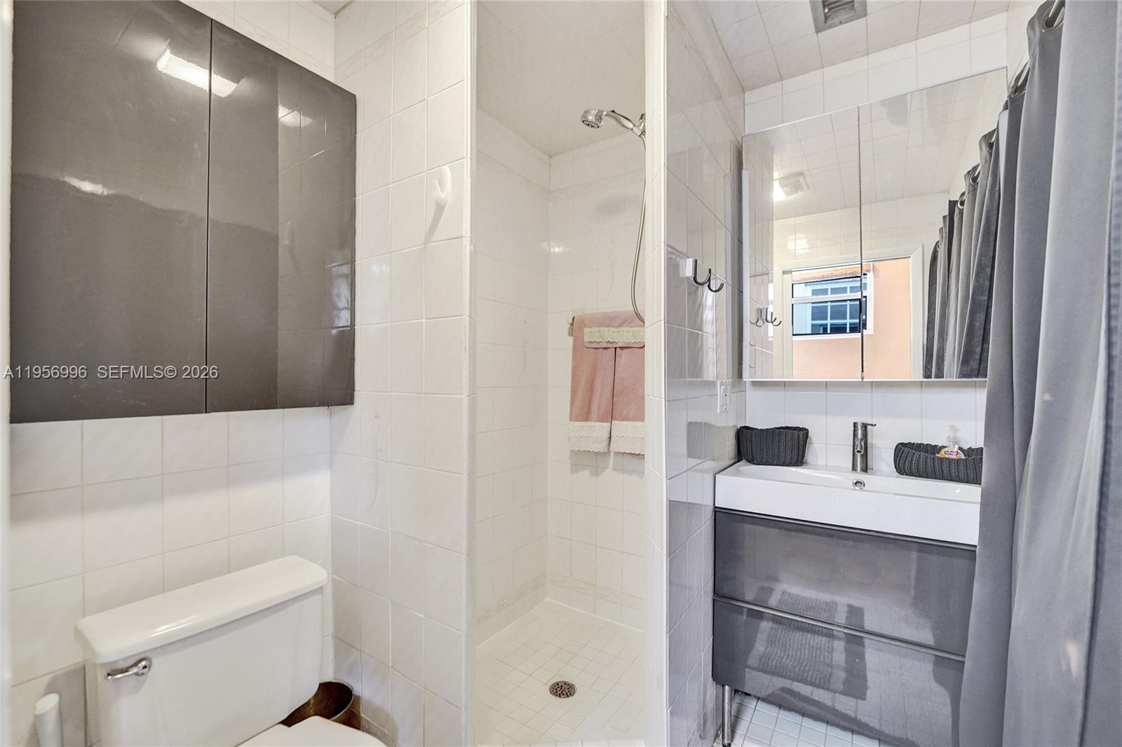 1340 Jackson Street Hollywood, FL 33019 - Photo 23 of 49 a bathroom with a sink a toilet a shower and a mirror