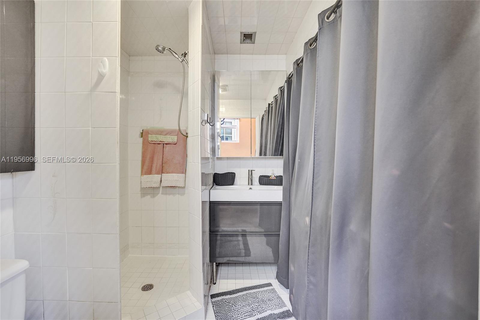 1340 Jackson Street Hollywood, FL 33019 - Photo 24 of 49 a bathroom with a bathtub and a shower