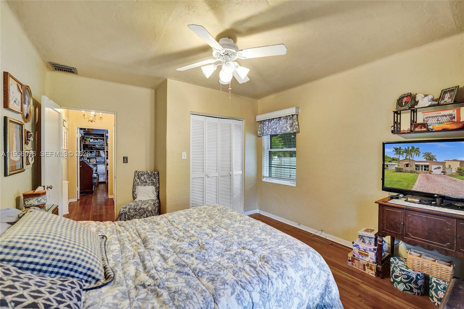 1340 Jackson Street Hollywood, FL 33019 - Photo 25 of 49 a bedroom with a bed and a chandelier