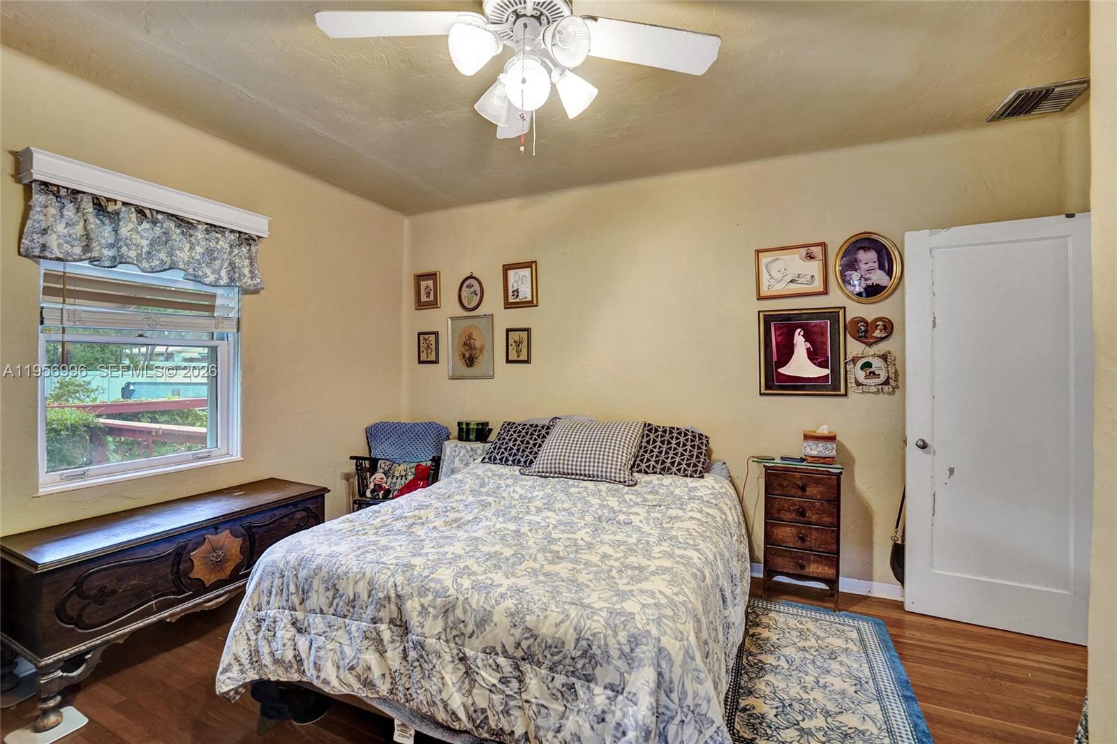 1340 Jackson Street Hollywood, FL 33019 - Photo 26 of 49 a bedroom with a bed and a chandelier