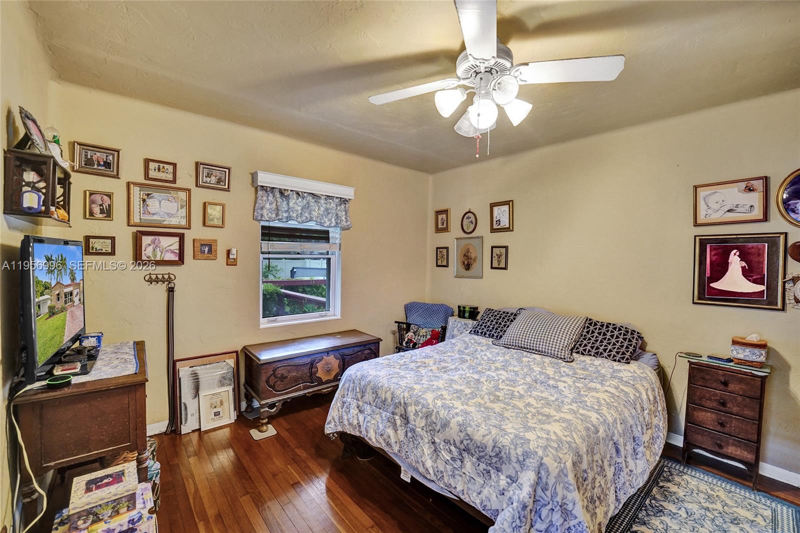 1340 Jackson Street Hollywood, FL 33019 - Photo 27 of 49 a bedroom with a bed a dresser with wooden floor
