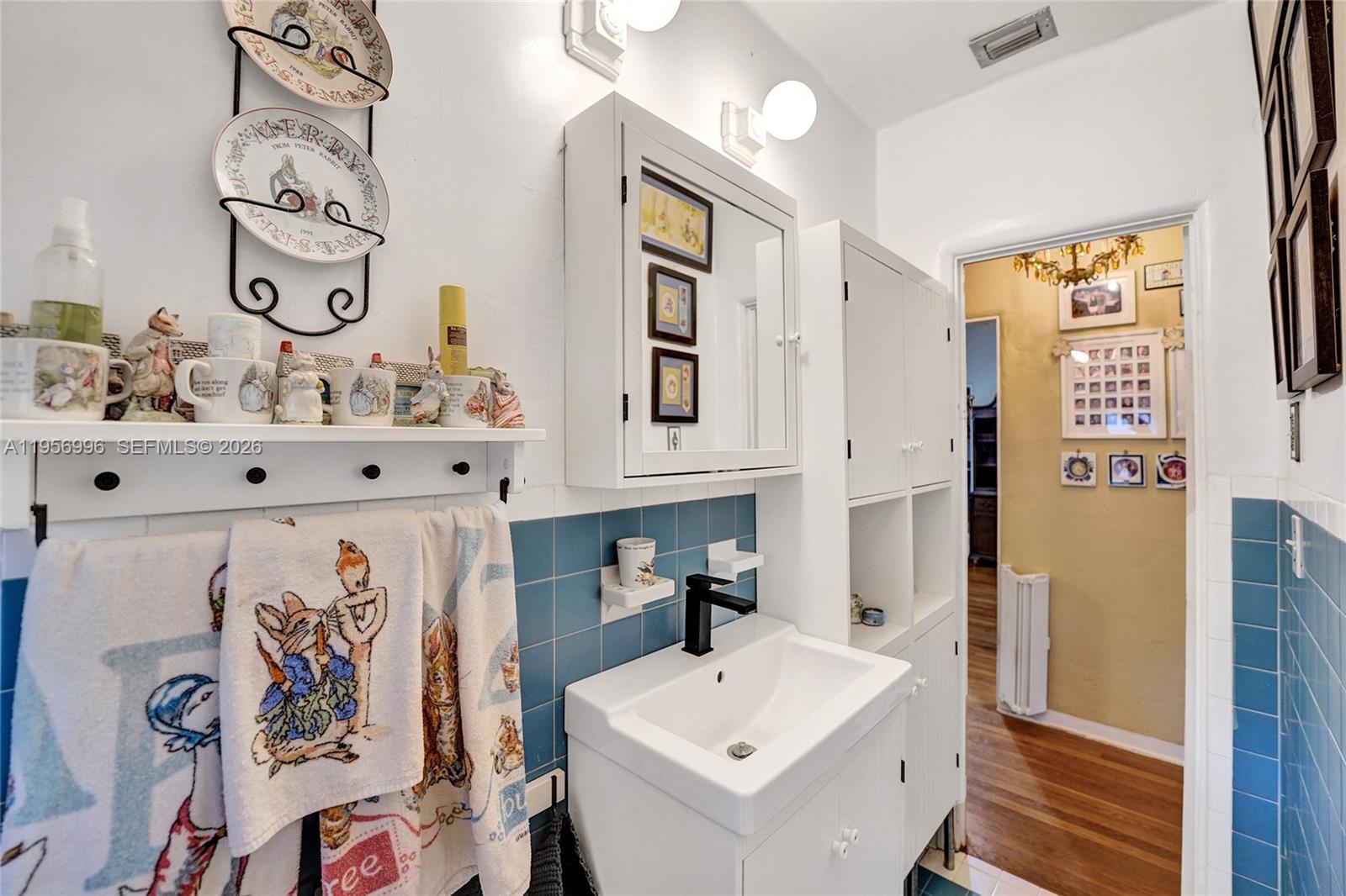 1340 Jackson Street Hollywood, FL 33019 - Photo 29 of 49 a bathroom with a sink and a mirror
