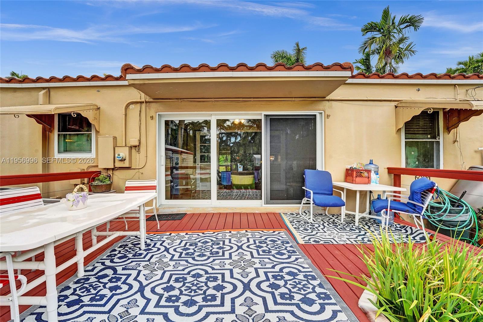 1340 Jackson Street Hollywood, FL 33019 - Photo 39 of 49 front view of a house with a lots of windows and potted plants