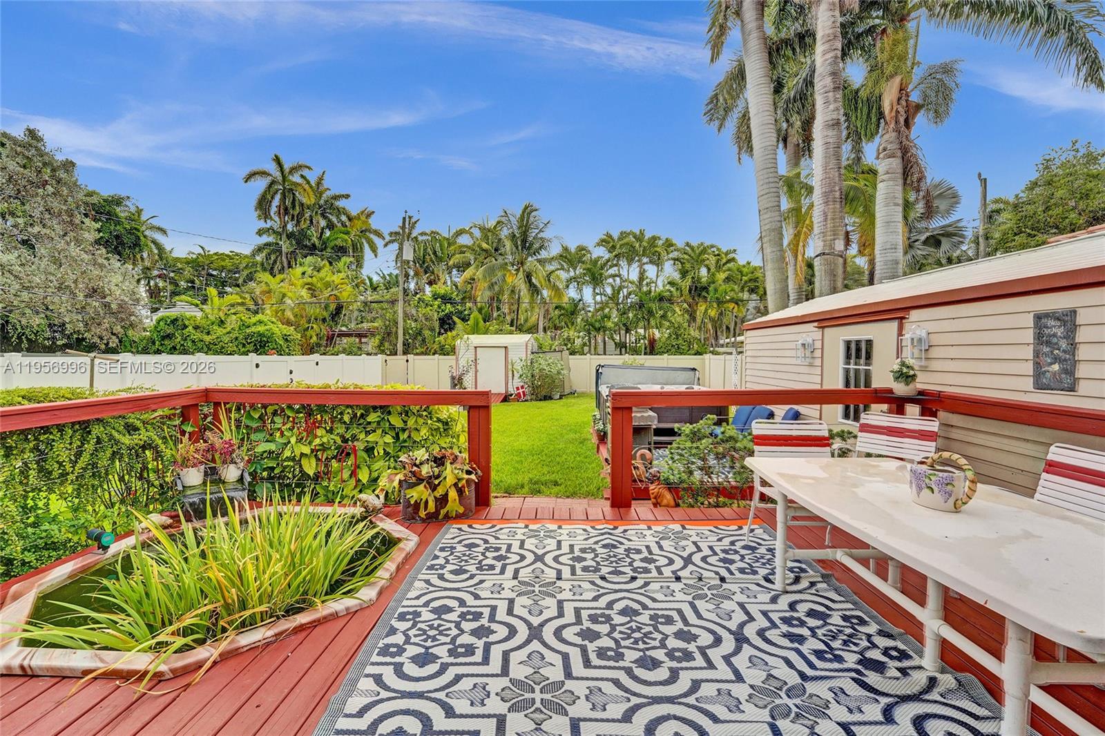 1340 Jackson Street Hollywood, FL 33019 - Photo 42 of 49 a view of a chairs and table in the backyard