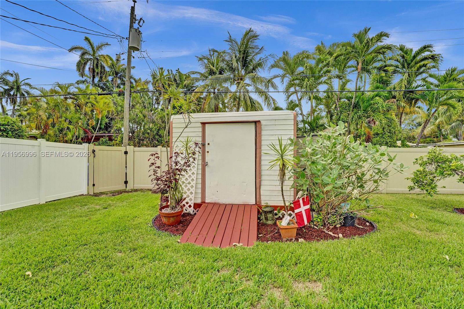 1340 Jackson Street Hollywood, FL 33019 - Photo 45 of 49 a view of a backyard with plants and a fountain