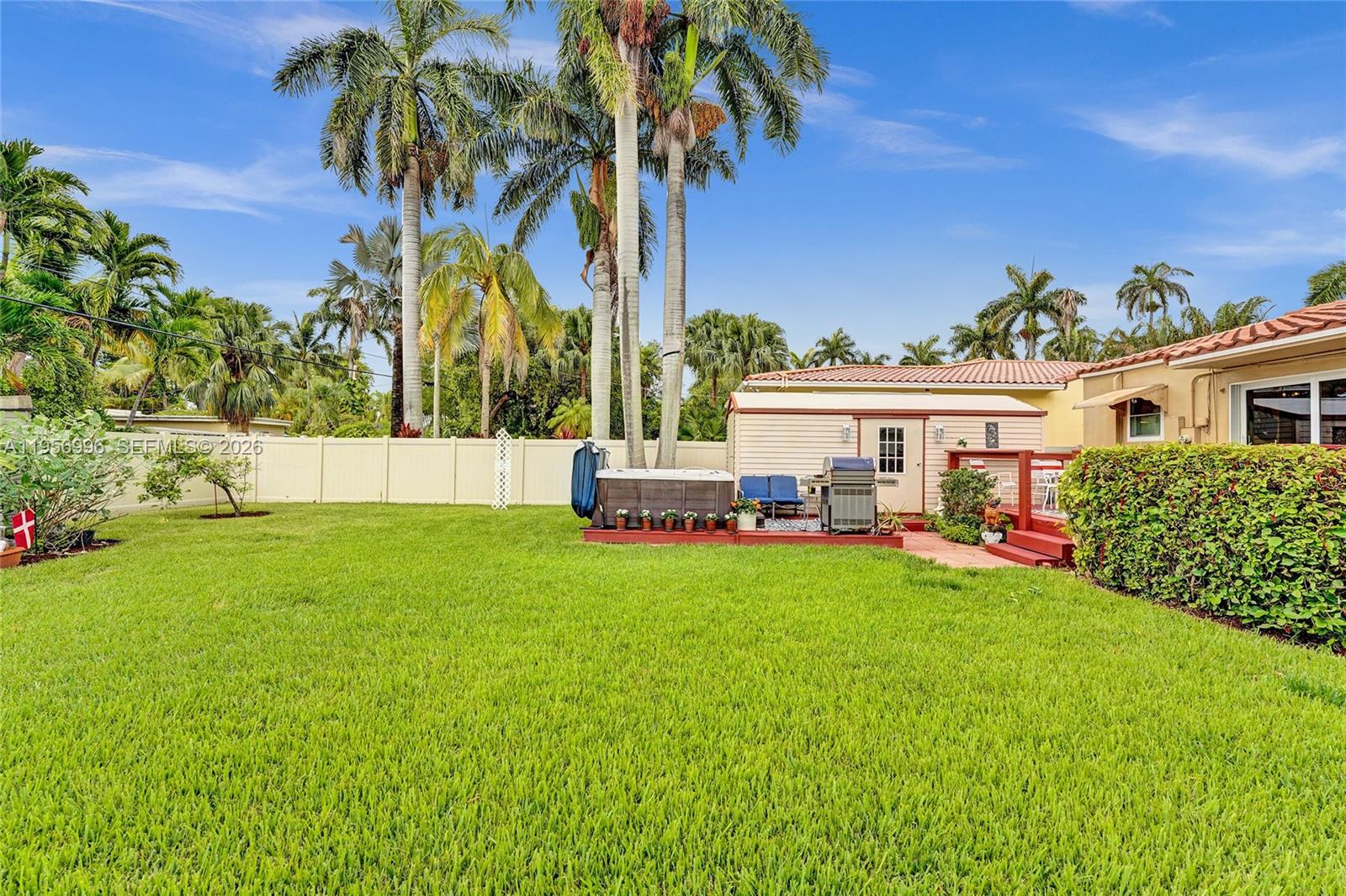 1340 Jackson Street Hollywood, FL 33019 - Photo 46 of 49 a view of a house with a backyard and a patio