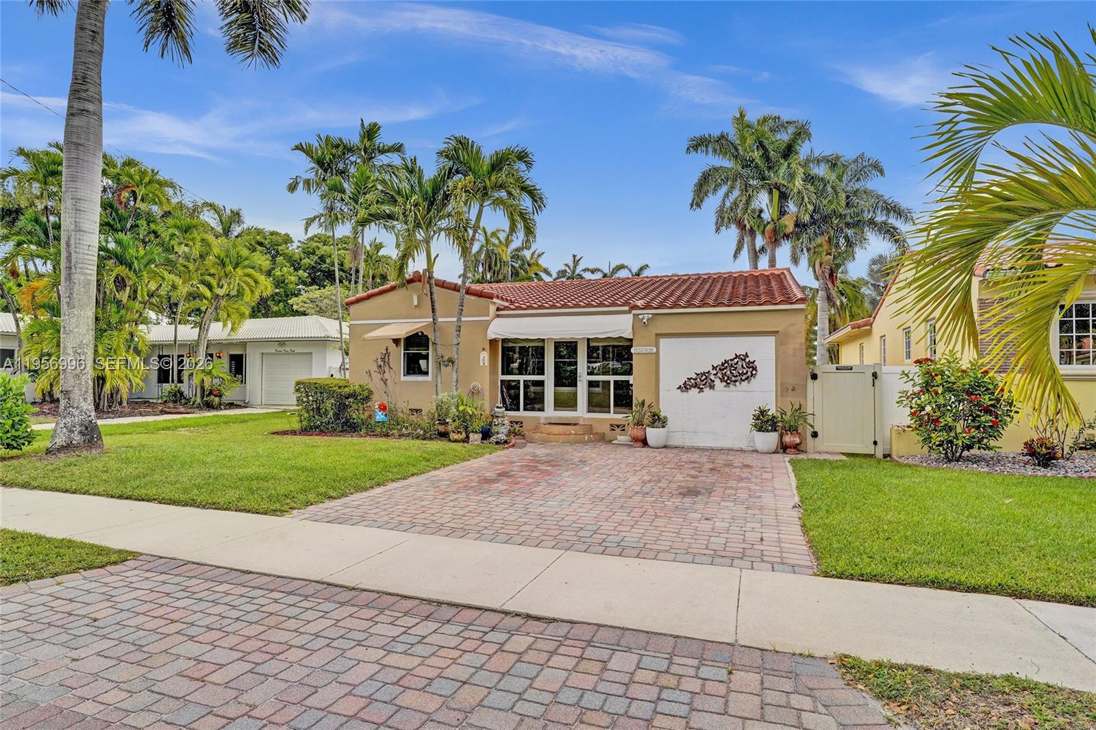 1340 Jackson Street Hollywood, FL 33019 - Photo 48 of 49 front view of a house and a yard