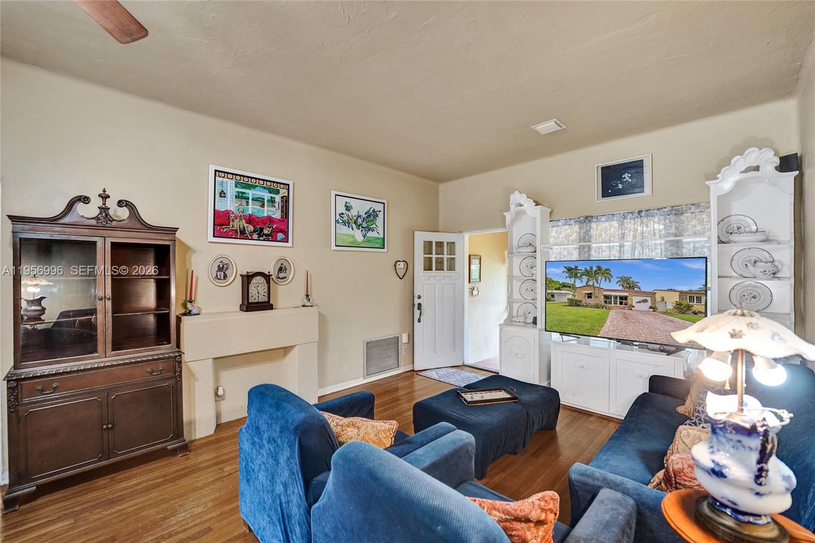 1340 Jackson Street Hollywood, FL 33019 - Photo 10 of 49 a living room with furniture and a flat screen tv