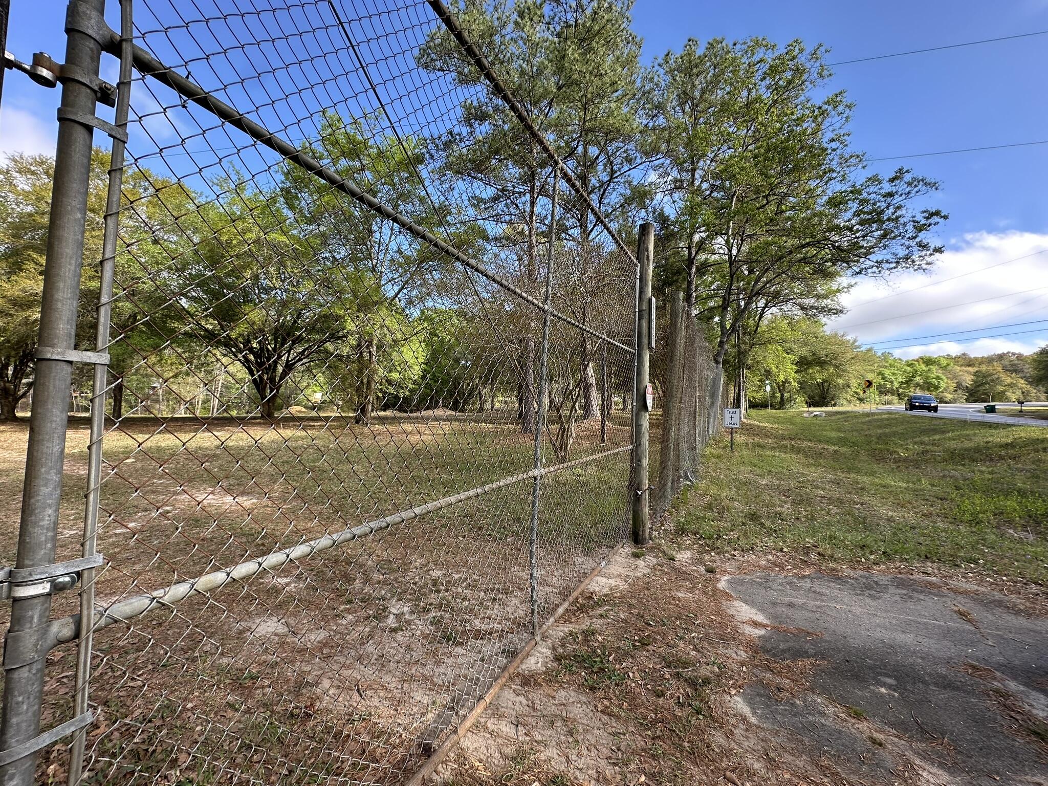 3421 Airport Road Crestview, FL 32539 - Photo 11 of 54 a view of a field with large trees