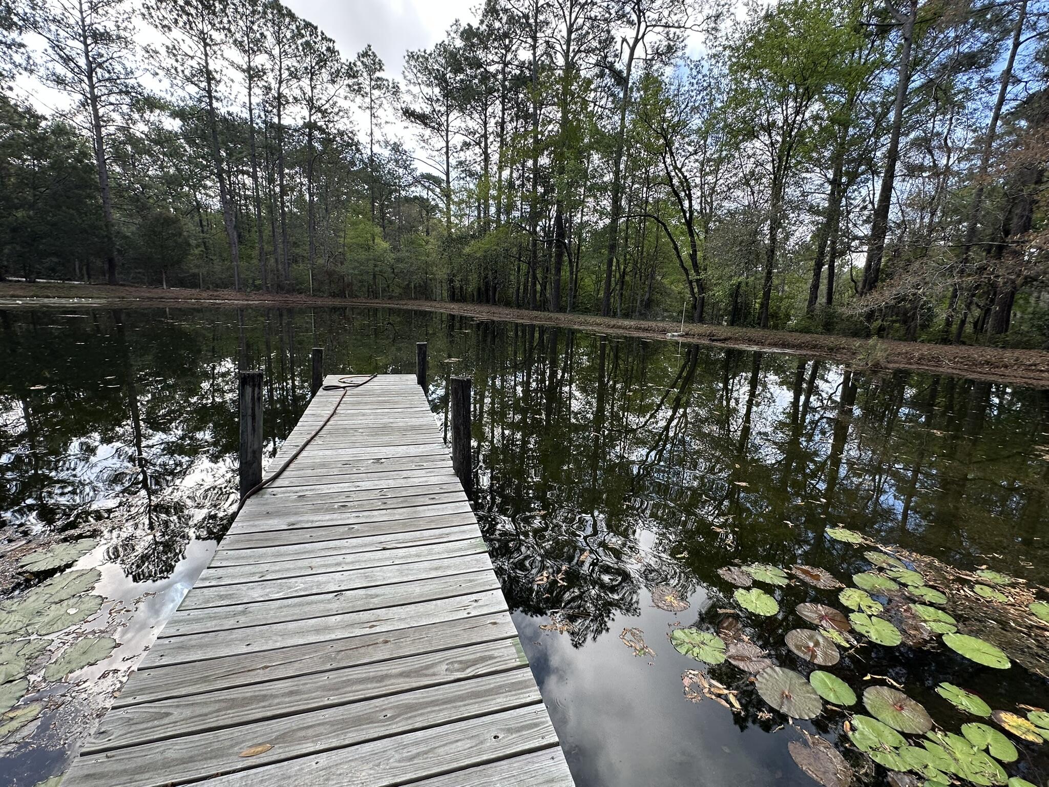 3421 Airport Road Crestview, FL 32539 - Photo 18 of 54 a view of wooden balcony with lake