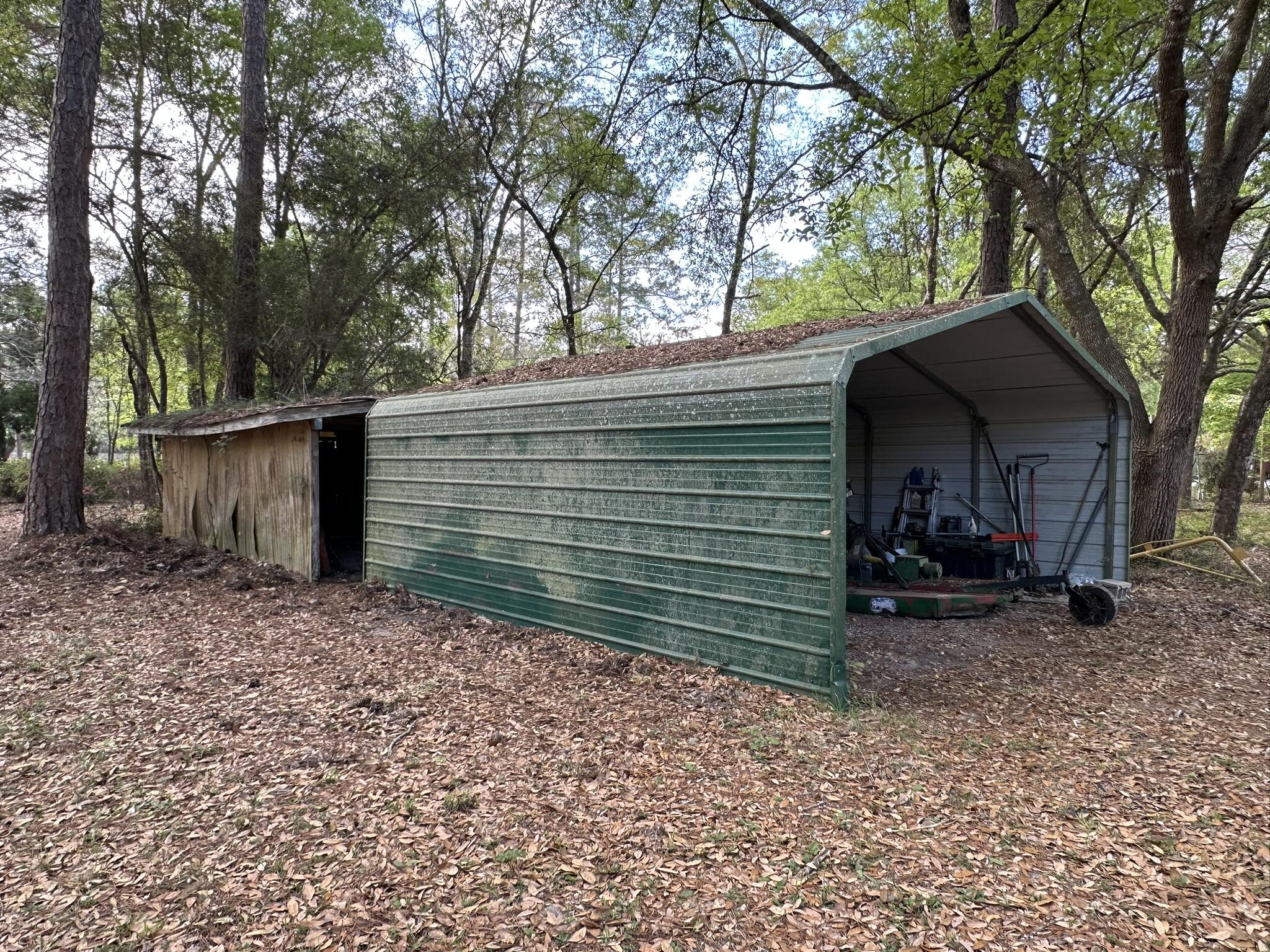 3421 Airport Road Crestview, FL 32539 - Photo 21 of 54 a view of a house with a yard and a tree