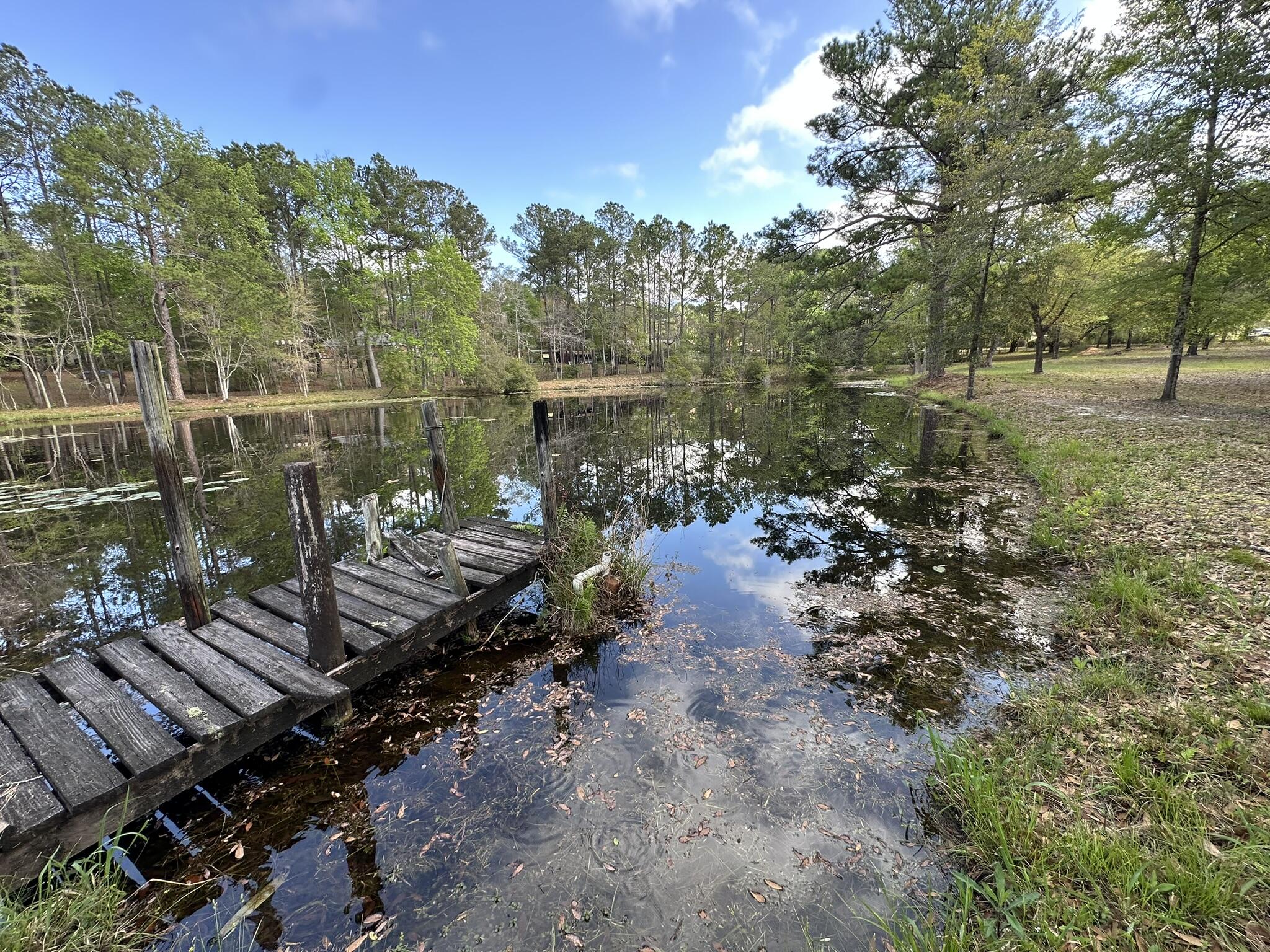 3421 Airport Road Crestview, FL 32539 - Photo 31 of 54 a view of a lake with a yard