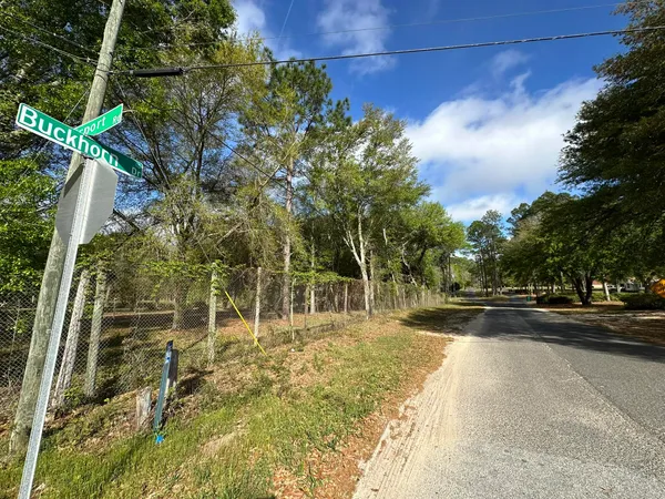 a view of a fence and trees