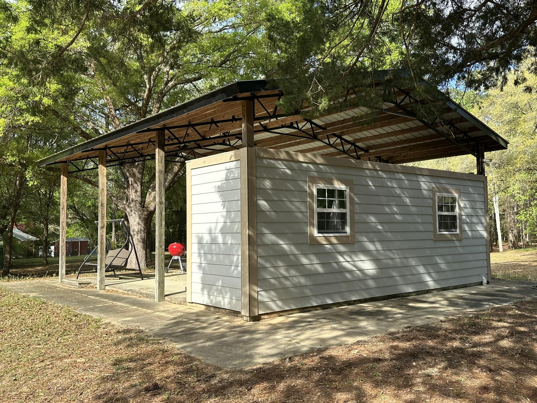 3421 Airport Road Crestview, FL 32539 - Photo 5 of 54 a view of a house with a backyard and a tree