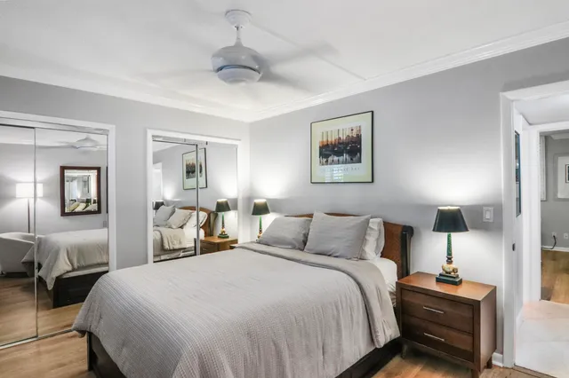 a bedroom with a bed and a painting on the wall