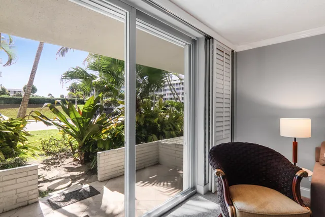 a living room with furniture and a floor to ceiling window