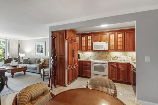 a kitchen with stainless steel appliances granite countertop a sink dishwasher stove and refrigerator