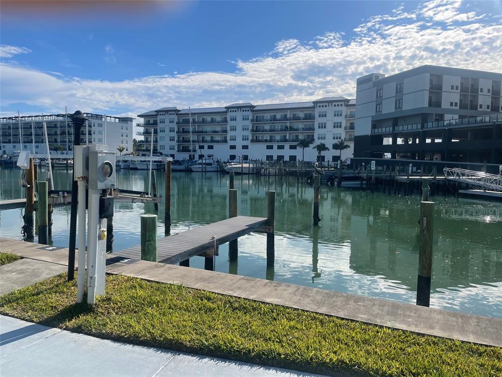 159 Medallion Boulevard, Unit E Madeira Beach, FL 33708 - Photo 15 of 15 a view of a lake with a house next to a lake