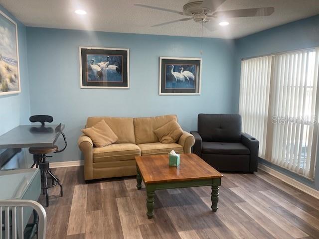 159 Medallion Boulevard, Unit E Madeira Beach, FL 33708 - Photo 2 of 15 a living room with furniture and a window
