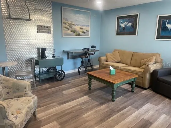 a living room with furniture a table and a lamp