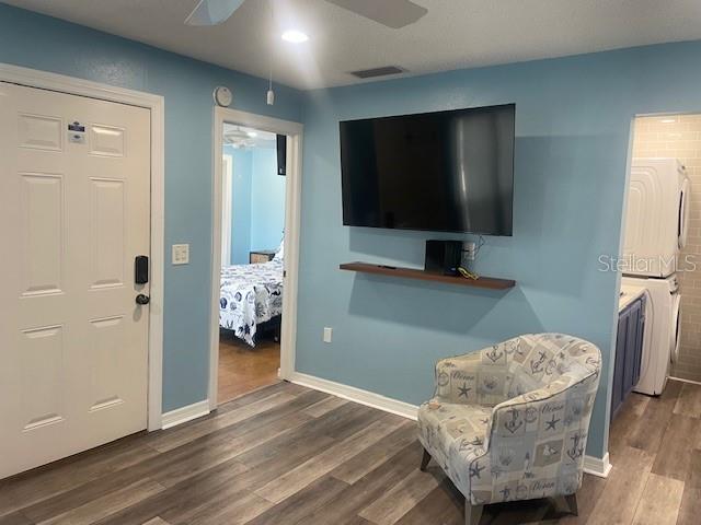 159 Medallion Boulevard, Unit E Madeira Beach, FL 33708 - Photo 4 of 15 a living room with furniture and a flat screen tv