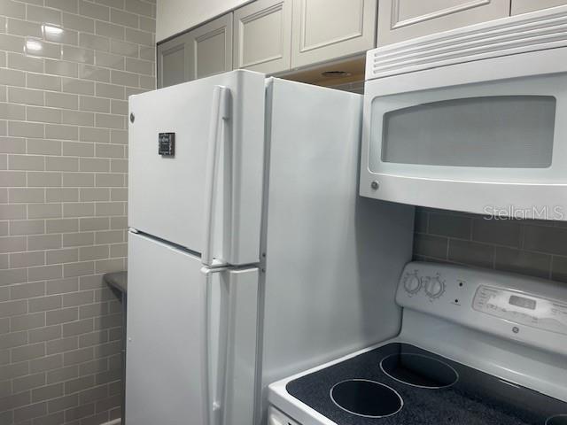 159 Medallion Boulevard, Unit E Madeira Beach, FL 33708 - Photo 6 of 15 a utility room with dryer and washer