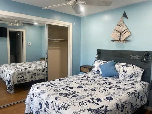 a bedroom with two beds and painting on the wall
