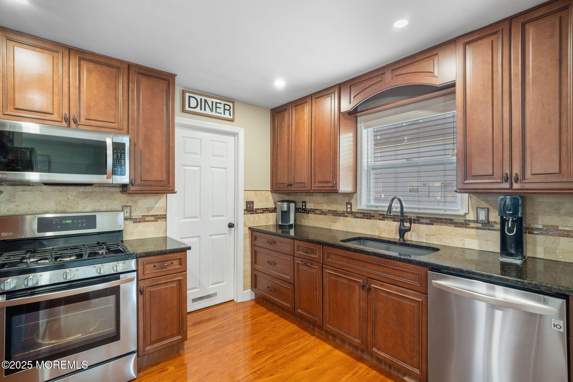 18 Red Maple Drive Brick, NJ 08724 - Photo 11 of 28 a kitchen with stainless steel appliances granite countertop a sink stove and microwave
