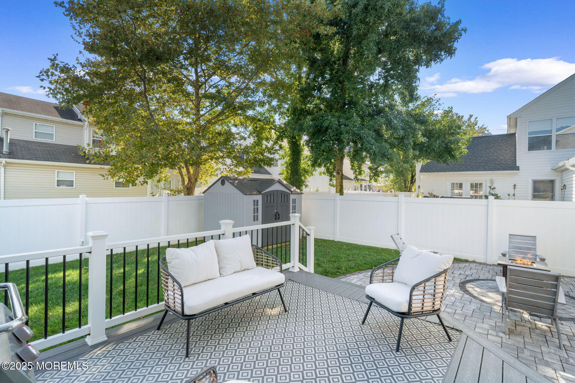 18 Red Maple Drive Brick, NJ 08724 - Photo 25 of 28 a view of a patio with a table and chairs with wooden fence and plants
