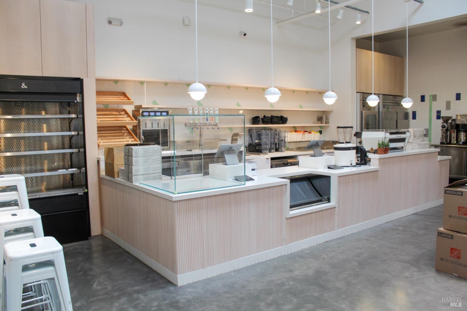 a kitchen with kitchen island a sink a stove and a refrigerator