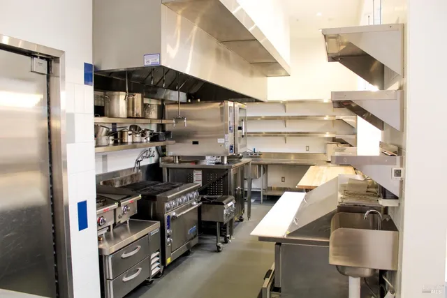a kitchen with a cabinets and a stove top oven