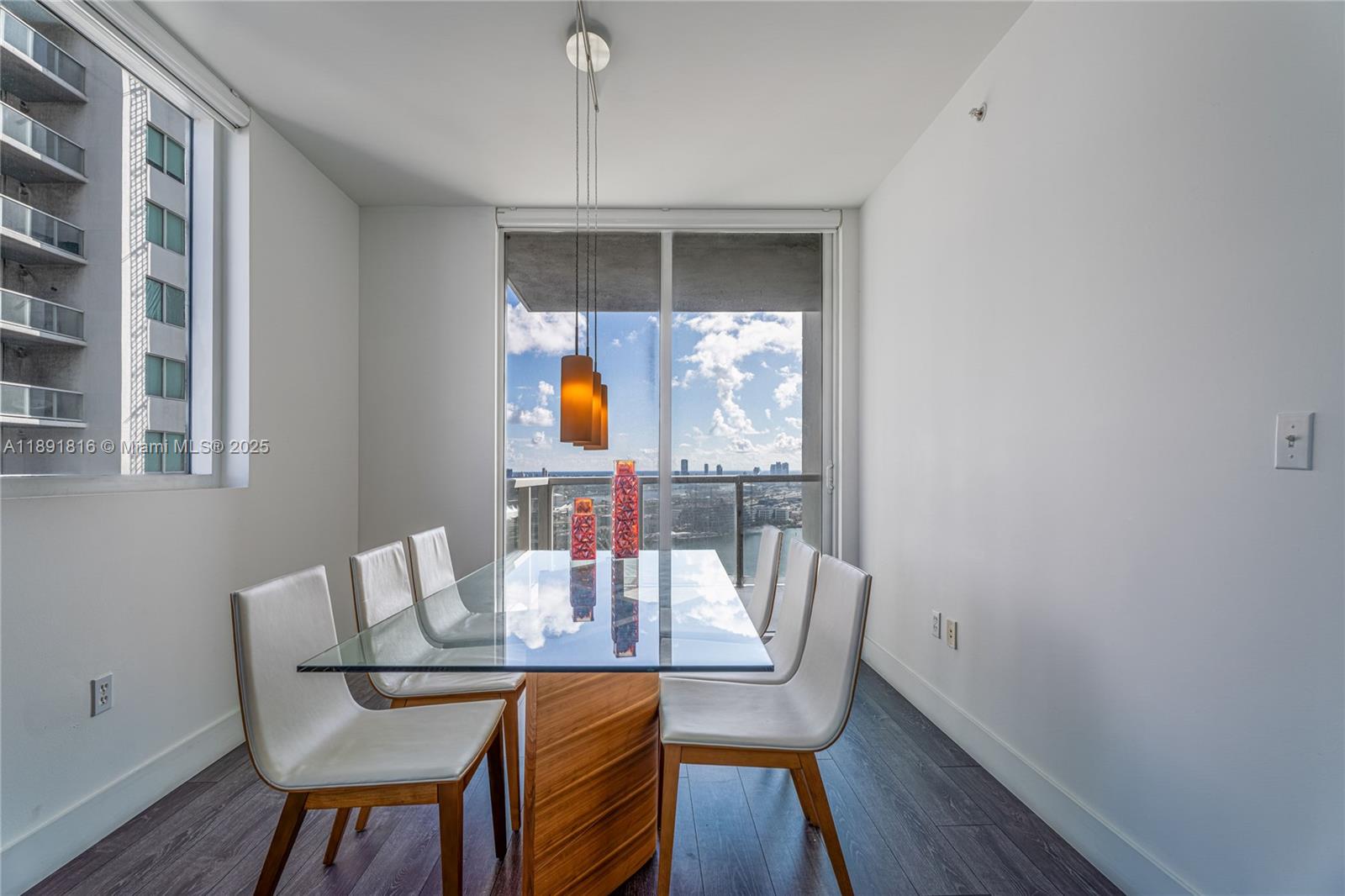 253 Northeast 2nd Street, Unit 3203 Miami, FL 33132 - Photo 11 of 29 a view of a dining room with furniture window and wooden floor