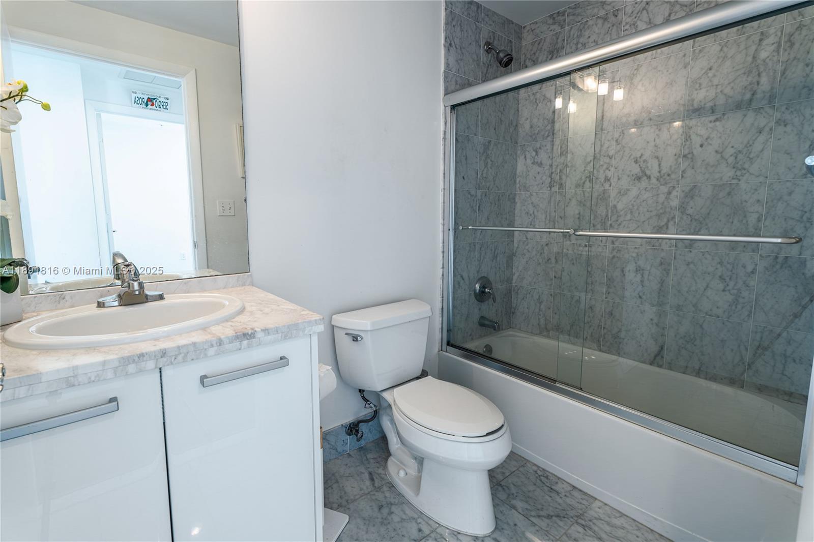 253 Northeast 2nd Street, Unit 3203 Miami, FL 33132 - Photo 14 of 29 a bathroom with a sink a toilet and shower
