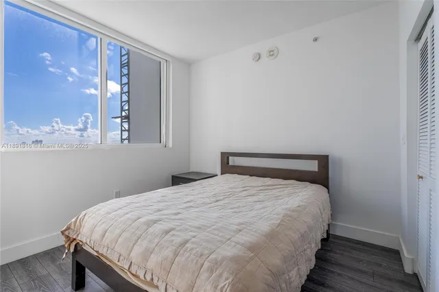 a large bed sitting in a bedroom next to a bathroom