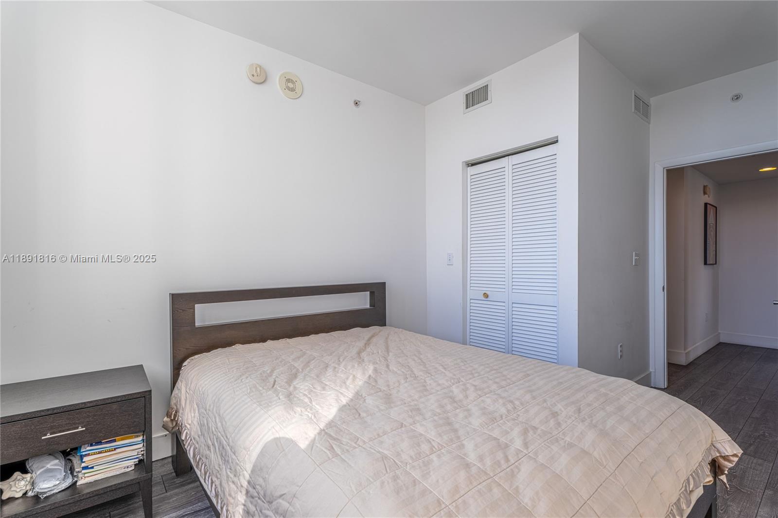 253 Northeast 2nd Street, Unit 3203 Miami, FL 33132 - Photo 16 of 29 a bedroom with a bed and a night stand