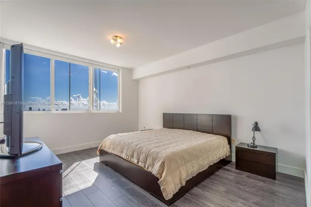 a bedroom with a bed and a desk