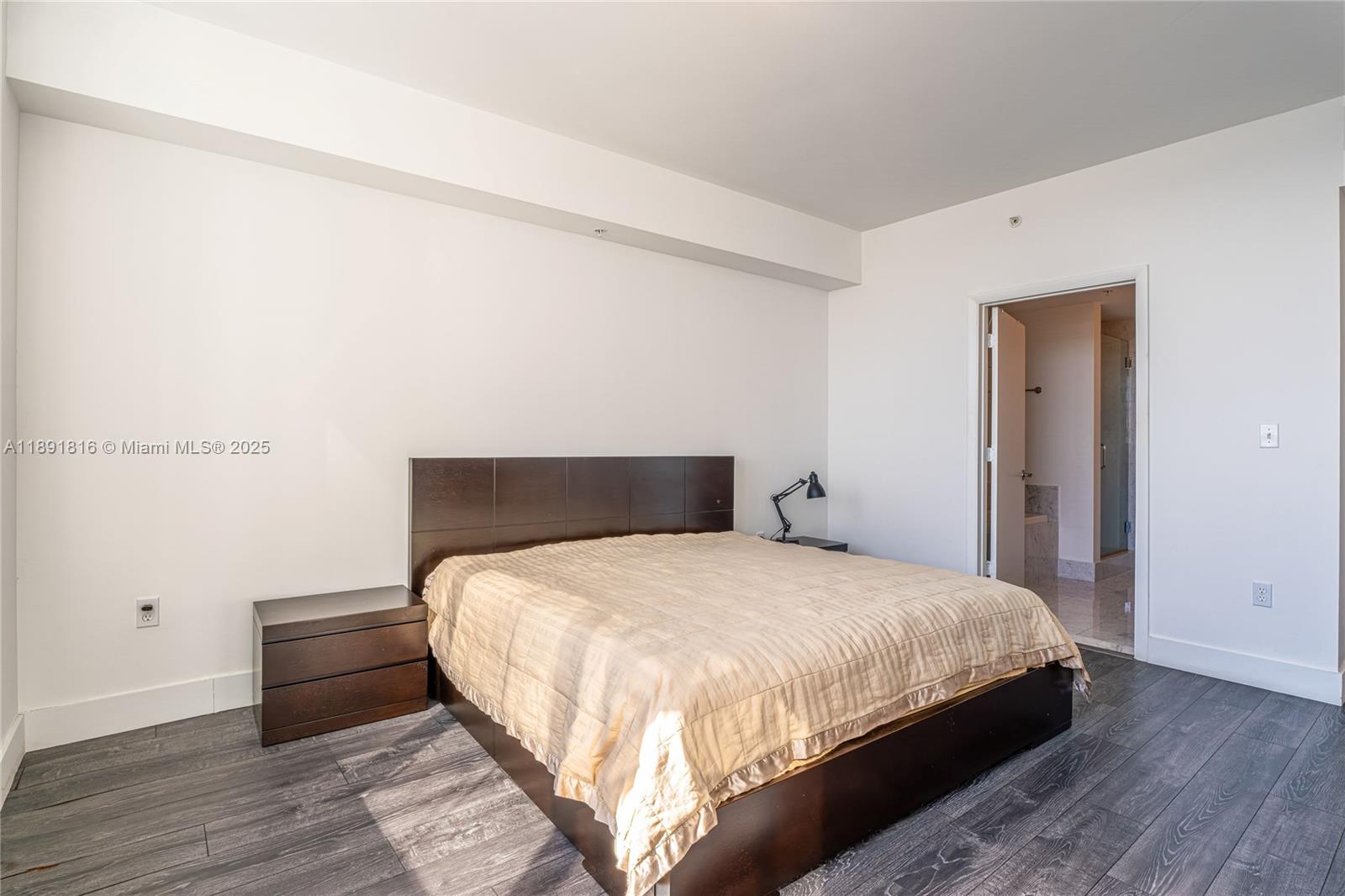 253 Northeast 2nd Street, Unit 3203 Miami, FL 33132 - Photo 18 of 29 a large bed sitting in a bedroom next to a cabinet