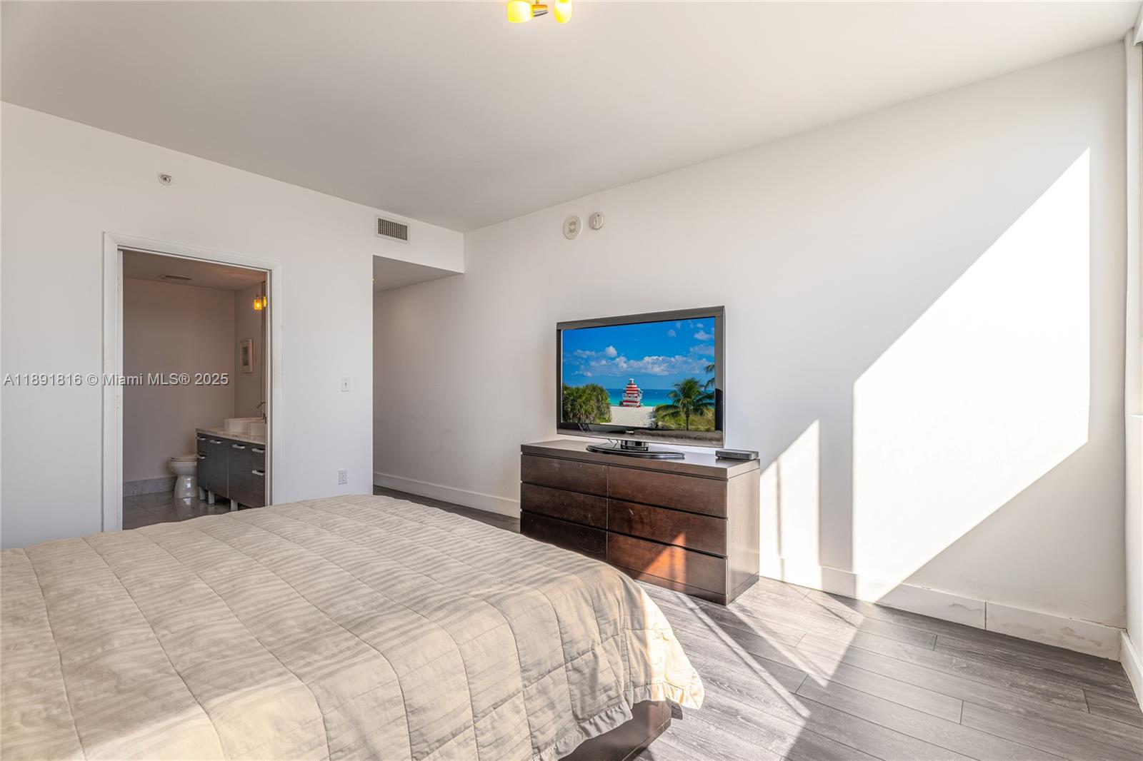 253 Northeast 2nd Street, Unit 3203 Miami, FL 33132 - Photo 19 of 29 a bedroom with a bed and a flat screen tv