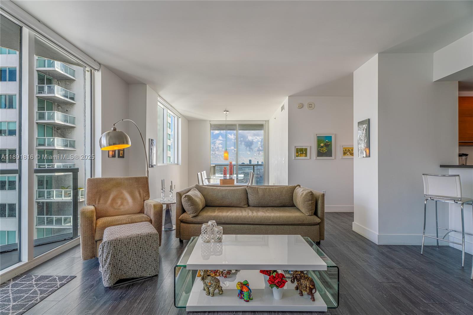 253 Northeast 2nd Street, Unit 3203 Miami, FL 33132 - Photo 3 of 29 a living room with furniture and a flat screen tv