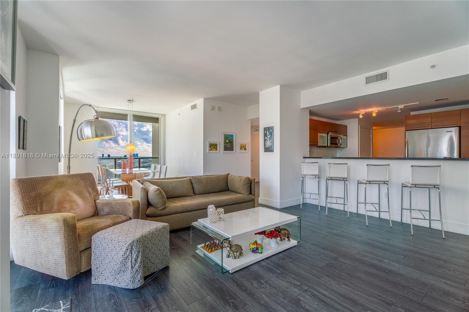253 Northeast 2nd Street, Unit 3203 Miami, FL 33132 - Photo 4 of 29 a living room with furniture and a wooden floor