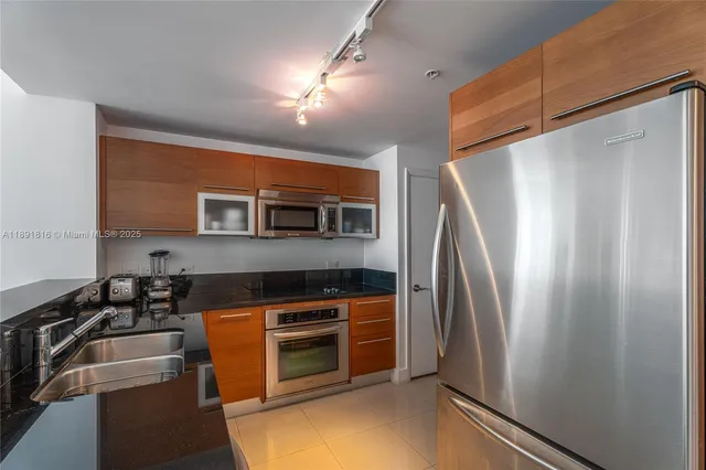 a kitchen with stainless steel appliances a refrigerator and a stove top oven