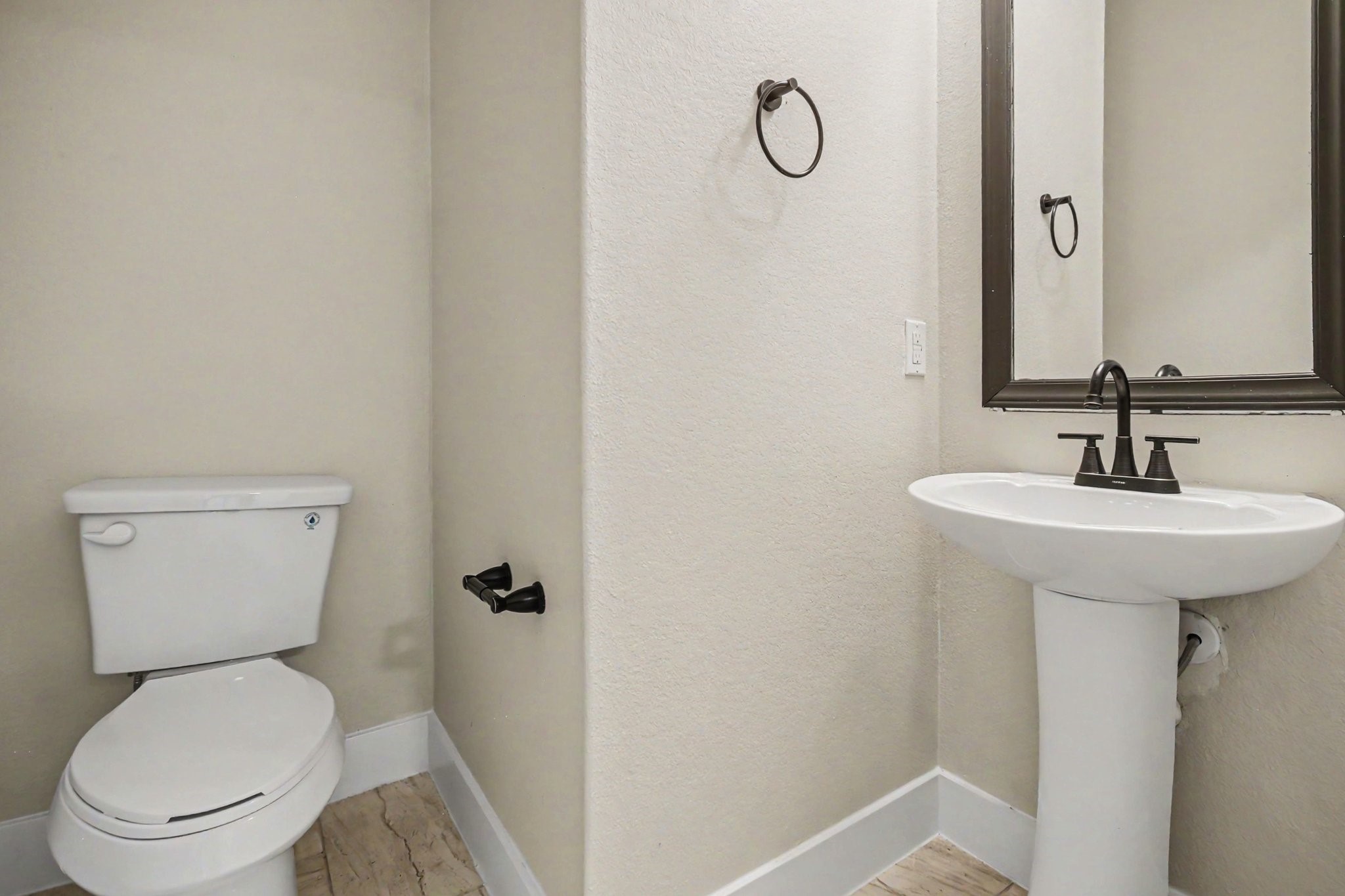 1322 Diamond Drape Drive Rosharon, TX 77583 - Photo 16 of 45 a white toilet sitting next to a bathroom sink