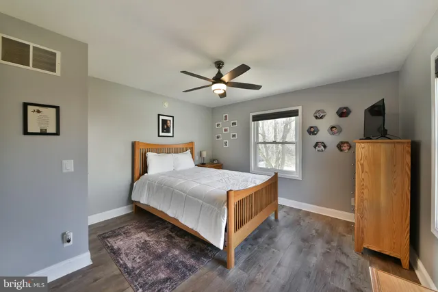 a bedroom with a bed and a large window