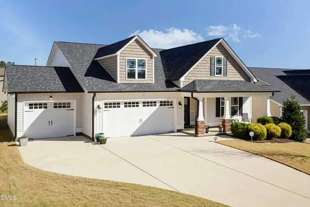 a front view of a house with a garden and pathway