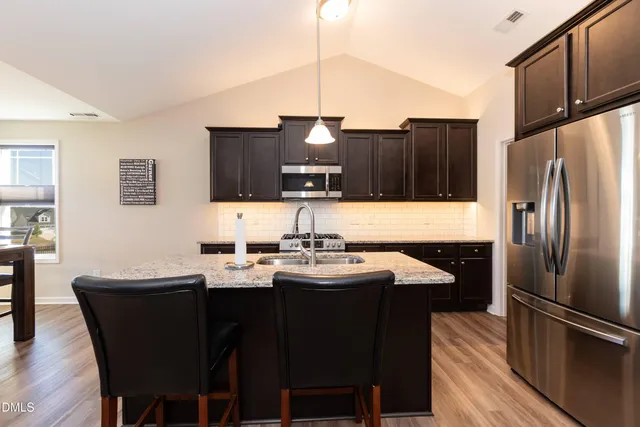 a kitchen with stainless steel appliances a sink stove and refrigerator