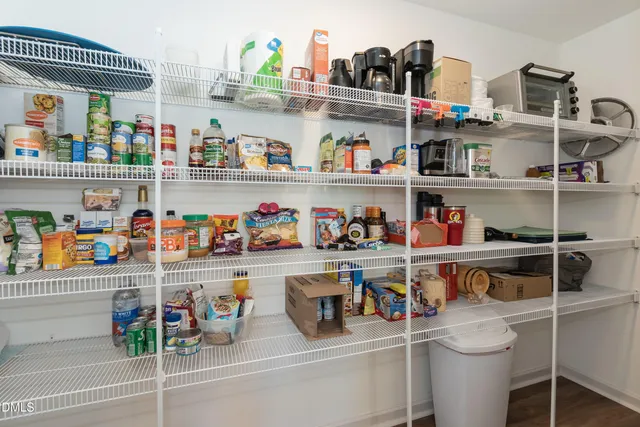 a cabinet with granite countertop lots of different kinds of food