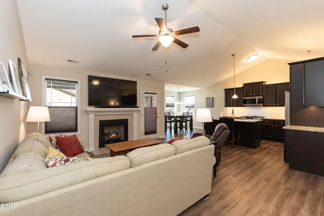 a living room with furniture fireplace and flat screen tv