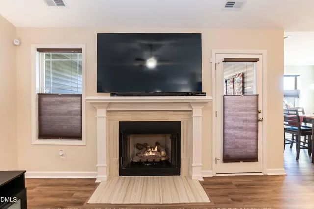 a living room with a fireplace and a flat screen tv
