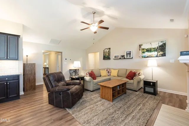 a living room with furniture and wooden floor